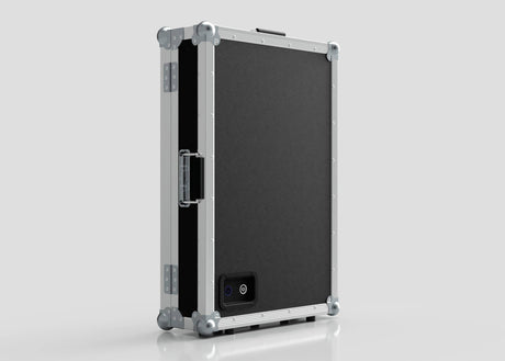 The Vanity Dressing Room Makeup Mirror Case is a black and silver hard-sided case with metal edges, corner protectors, a side handle, and a small rectangular power port on one side.
