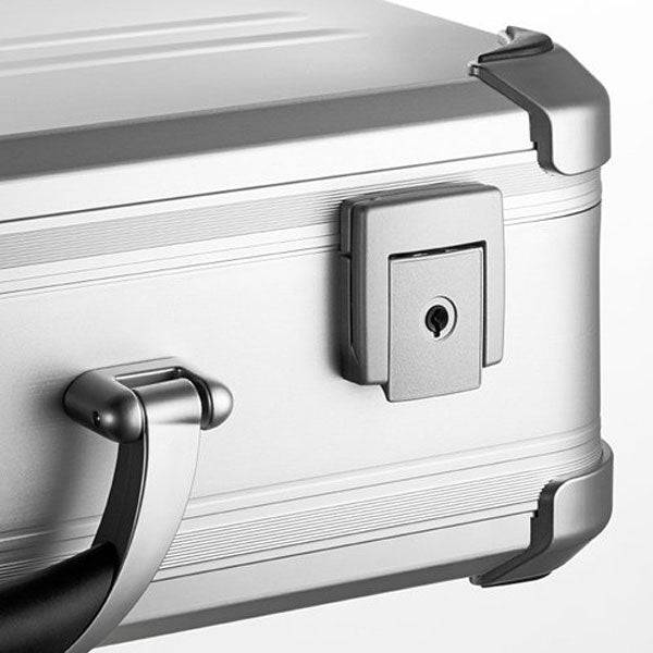 A close-up of the VDK 97100 silver aluminium case highlights its handle, metal corner protectors, and built-in lock.
