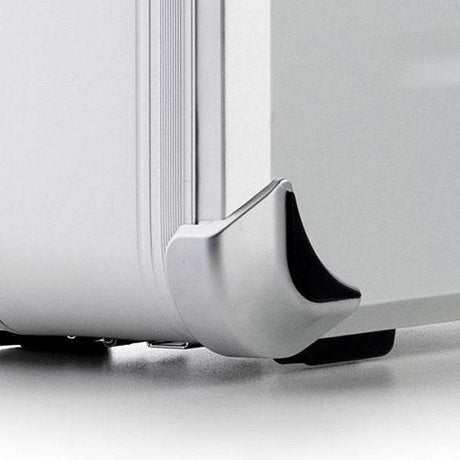 Close-up of the VDK 97100 silver aluminium case corner, showcasing its reinforced protective metal corner and part of the suitcase wheel.