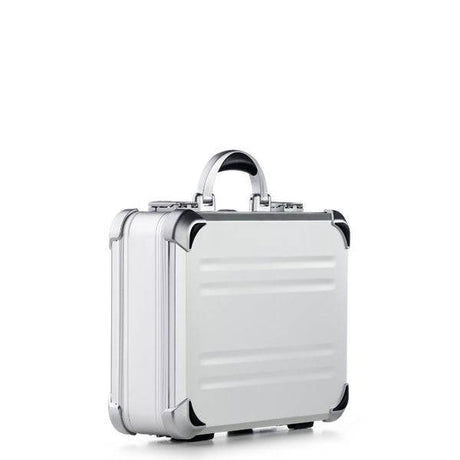 The VDK 97100, a silver aluminium case with rounded corners, a handle, and custom CNC foam fittings, stands upright against a plain white background.