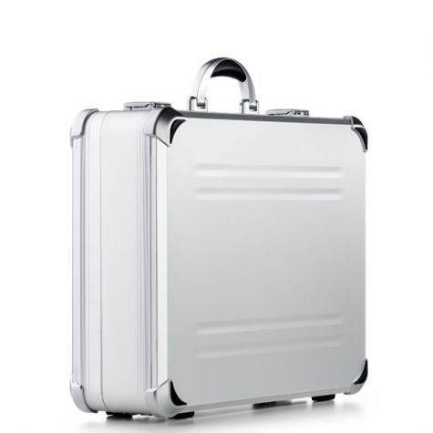 The VDK 97700 features a silver aluminium case with black corner protectors, custom CNC foam fittings, and a metal handle, shown upright on a white background.