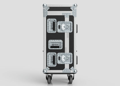 A Yamaha DM7 Compact Case in black and silver, featuring four metal latches, reinforced corners, and four caster wheels, stands upright against a plain gray background.