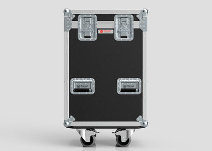 The Yamaha DM7 Compact Case is a large black flight case with metal reinforcements, two top latches, two front handles, and four caster wheels on the bottom, shown against a plain background.